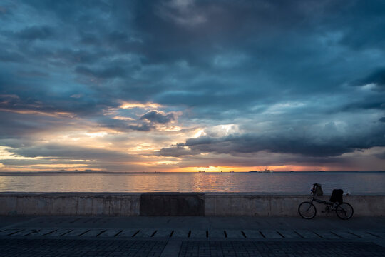 Sun setting in Manila Bay, Philippines. One of the netizen left his bike nearby.