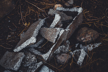 Broken concrete block on straw in the field