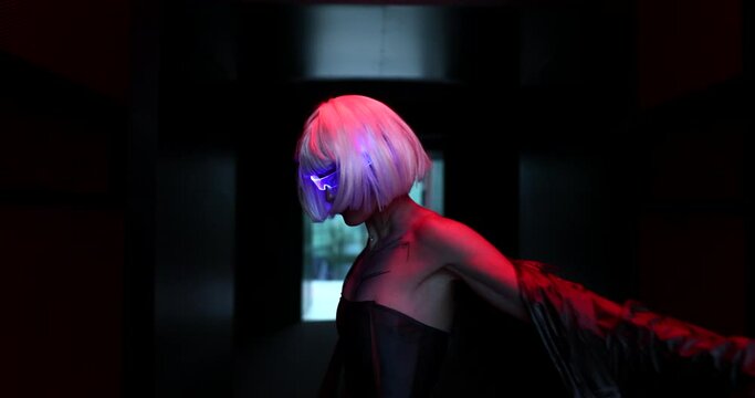 Art cyberpunk video with a woman in glowing glasses. The video has the effect of grain, noise.
