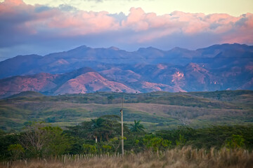 Cuba. Bright sunset over the hills covered with tropical plant