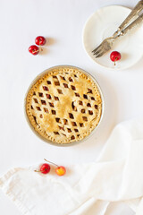 Homemade sweet cherry pie on a white background.