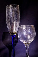 Glass with raindrops on a black background.