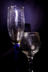 Glass with raindrops on a black background.