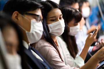 Crowd of passengers on Urban Public Transport Metro. .Asian people go to work by public transport. Face Mask protection against virus. Covid-19, coronavirus pandemic