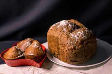 Delicious cupcakes with strawberries and bread on a plate.