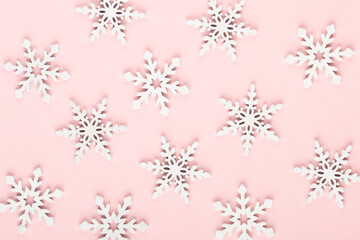 Naklejka na ściany i meble Christmas background. White snow decorations on a pink background.
