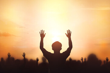 Worship concept:  christian people Raise hand over  cross on spiritual sky background