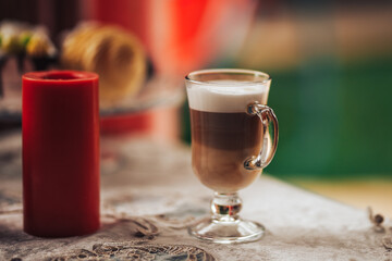 Glass mugs with delicious coffee on the table, sweet pastries, coffee break, family gatherings.