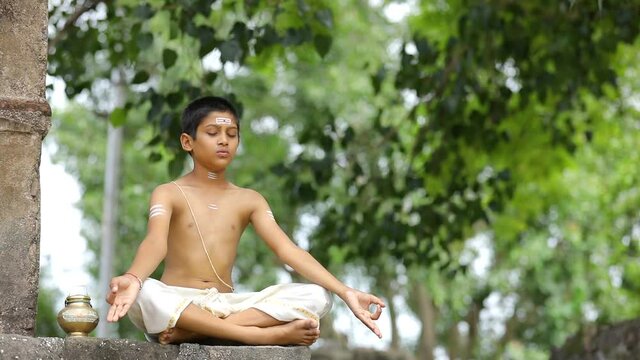 Young indian child  doing yoga in the park