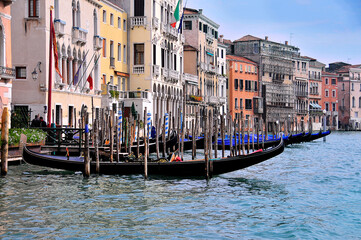 Fototapeta na wymiar Venetian gandols against the background of old facades of houses