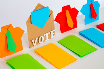 Voting ballots and origami men are placed diagonally. The concept of participation in elections. Bright background about voting in elections.