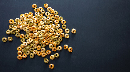 Pasta tortellini on black background, top view. Cooking italian cuisine concept