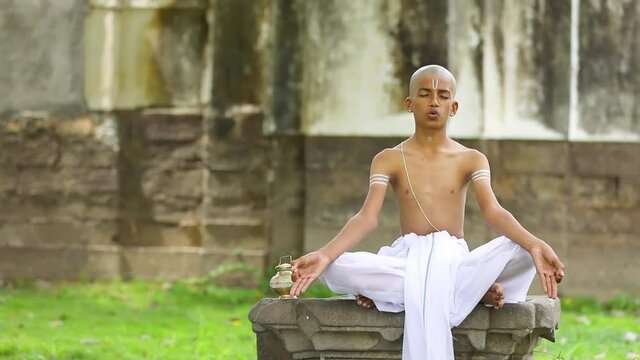 Young indian child  doing yoga in the park