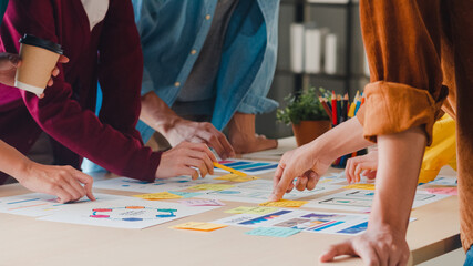 Asian businessmen and businesswomen meeting brainstorming ideas about creative web design planning...