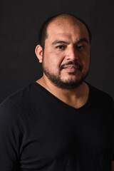portrait of a latin american man on black  background