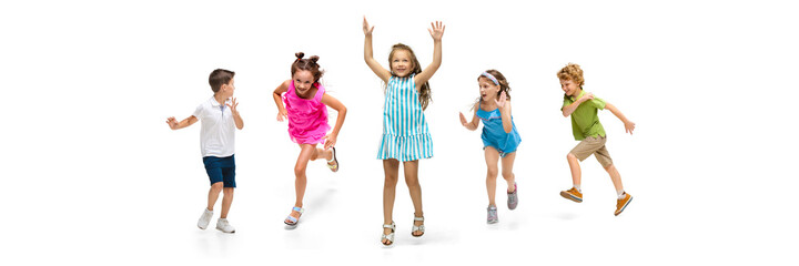 Happy children, little and emotional caucasian kids jumping and running isolated on white...