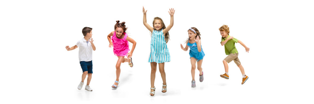 Happy children, little and emotional caucasian kids jumping and running isolated on white background. Looks happy, cheerful, sincere. Copyspace for ad. Childhood, education, happiness concept.