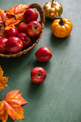 Fresh harvest of apples. Basket with fresh apples on aged table. Copy space for text.