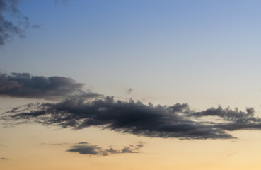 dark grey clouds against sunset sky color gradient