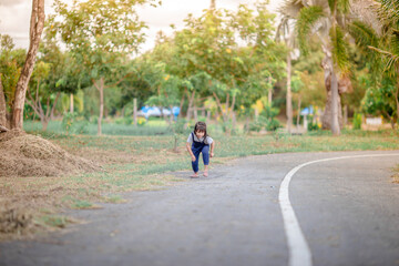 Blurred abstract background of Asian girls, cute in a bright dress, playing on the street or in a park, when parents watch closely.