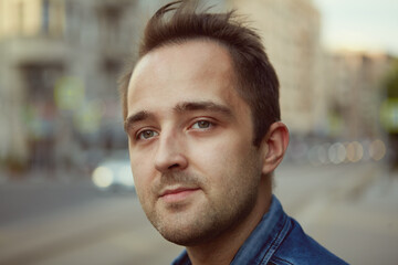 Fototapeta premium Young pensive white man on street.