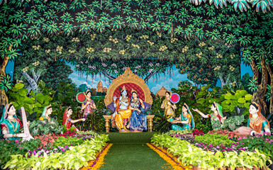 Colorful life size idols of Krishna,Radha & Gopis sitting at Prem Mandir temple.