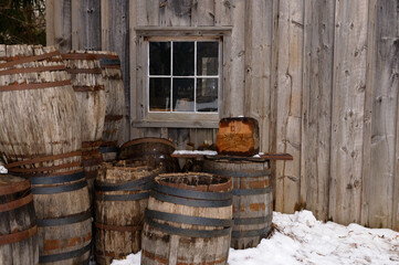 Old barrels outside the cooperage in winter at Pioneer Village