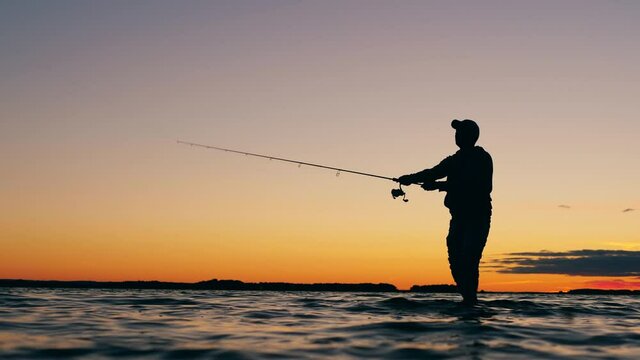 Sunset lake with a man casting a fishing rod