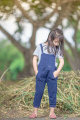 Blurred abstract background of Asian girls, cute in a bright dress, playing on the street or in a park, when parents watch closely.
