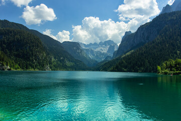 View of majestic mountains and lake in Europe.Nature getaway.Turquoise water of Gosau See,lake,Austria,Dachstein glacier in background.Vacation travel scene.Alpine lake surrounded by mountains