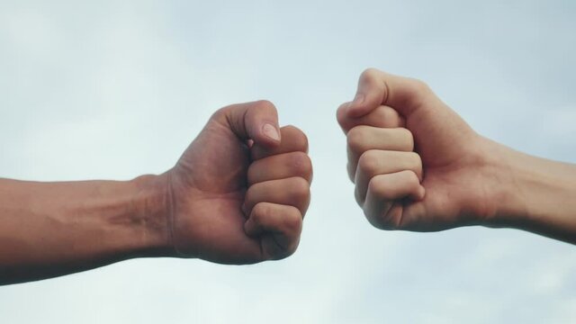 teamwork concept. fist to fist commit solidarity a respect and brotherhood gesture. business team hands fists close-up. people lifestyle of different skin colors partnership friendship teamwork