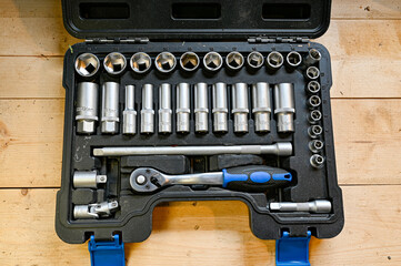 set of socket wrenches on wooden bench
