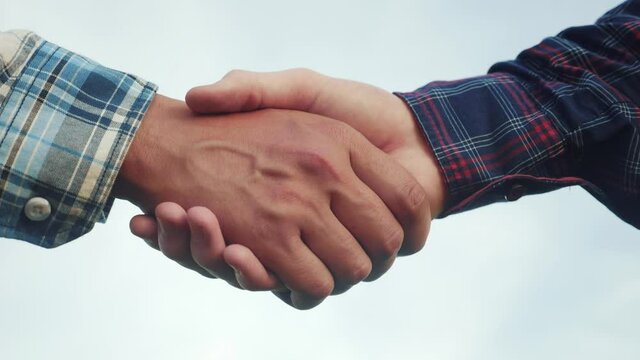 teamwork handshake concept. two people shake hands lifestyle shaking hands. different skin colors shake hands conclude a business contract close-up. people of different skin colors partnership