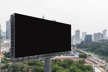 Blank black road billboard with Kuala Lumpur cityscape background at day time. Street advertising poster, mock up, 3D rendering. Side view. The concept of marketing communication.