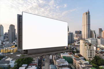 Blank white road billboard with Bangkok cityscape background at sunset. Street advertising poster, mock up, 3D rendering. Side view. The concept of marketing communication to promote or sell idea.