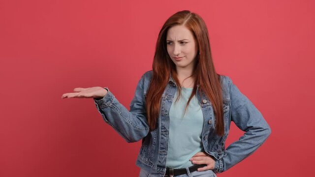 Caucasian young woman isolated over turquoise background unhappy for not understand something.