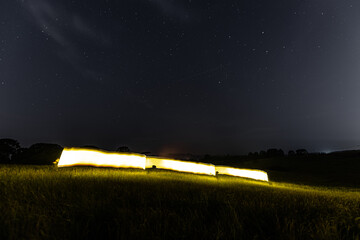 Painting with light bat on a nocturnal pasture