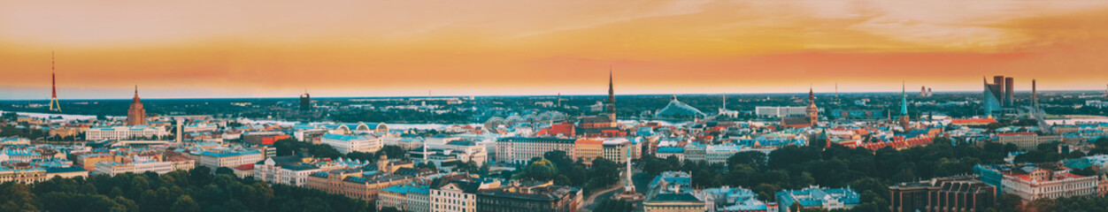 Fototapeta na wymiar Riga, Latvia. Aerial View Panorama Cityscape At Sunset. TV Tower, Academy Of Sciences, St. Peter's Church, Boulevard Of Freedom, National Library, Dome Cathedral, Basilica Of St. James
