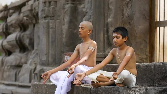 Young indian child  doing yoga in the park