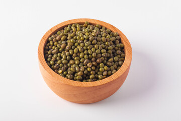 Green beans in a wooden cup on a white background