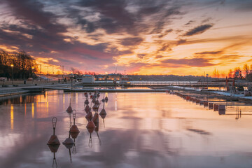 Helsinki, Finland. Landscape With City Pier, Jetty At Winter Sunrise Or Sunset Time. Tranquil Sea Water Surface At Early Morning