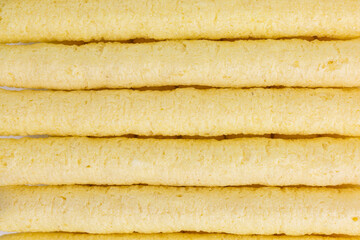 background of bio puffed corn sticks snack