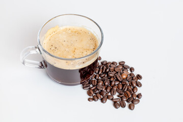 A glass of coffee grinder with coffee beans on white background