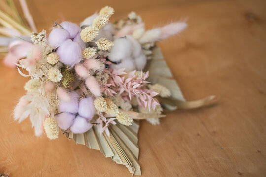 Interior bouquet of dried flowers for home decor with cotton flowers, palm leaves, eucalyptus.