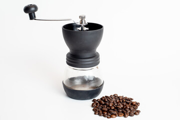 coffee grinder with coffee beans on white background