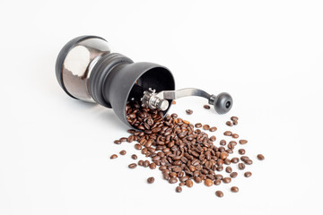 coffee grinder with coffee beans on white background