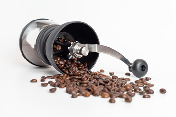 coffee grinder with coffee beans on white background