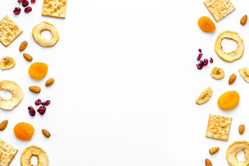 Snacks mix frame top view. Nuts and dried fruits with crackers, copy space