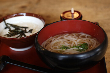 Close up of a bowl of delicious udon (Japanese noodles) served with a bowl of yam, Nara, Japan, soft focus