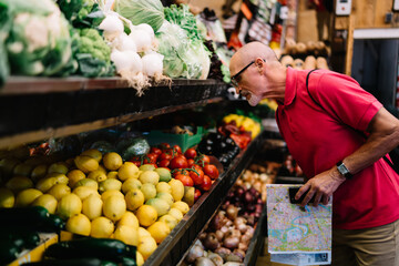 Adult male picking vegetables in shop